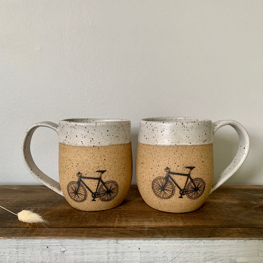 pottery bike mug. The bike is featured on the natural brown speckled clay and accented with a soft white matte glaze on the handle and rim