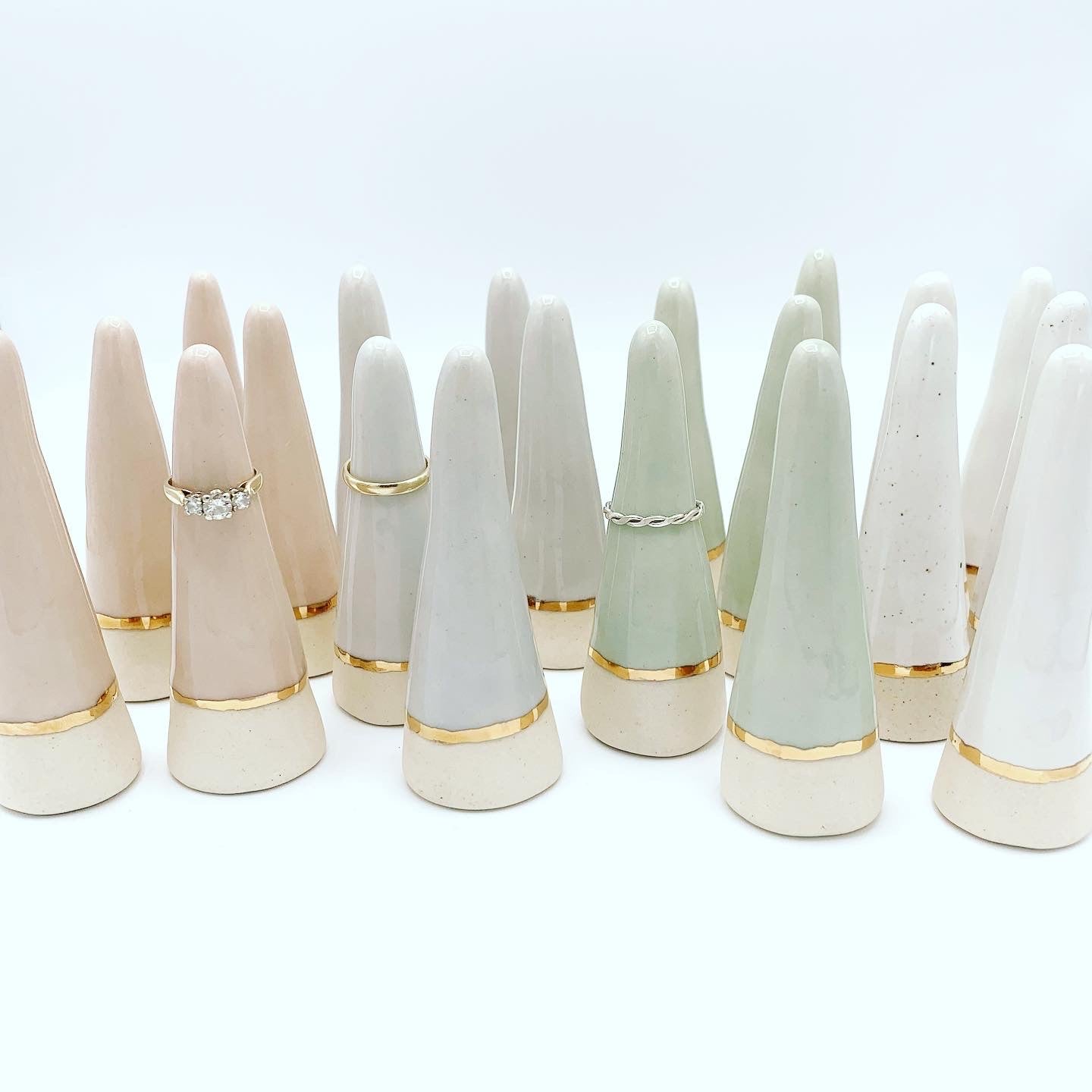 pastel colour ceramic ring cones accented with a 22K gold band at the bottom. Comes in pink, light blue, light green and white.