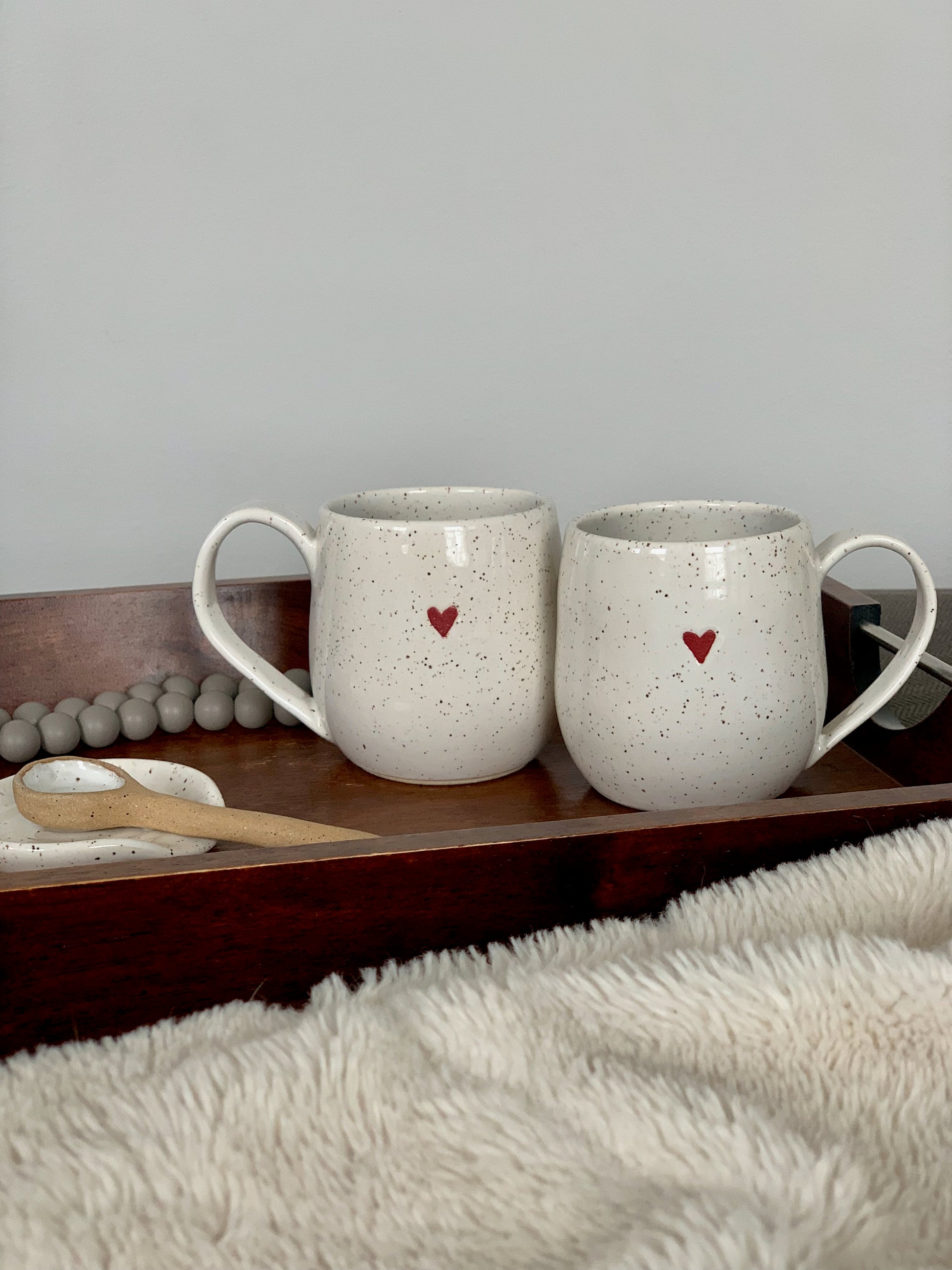 ceramic white speckle sweetheart mugs with a cute little red heart. Microwave and dishwasher safe