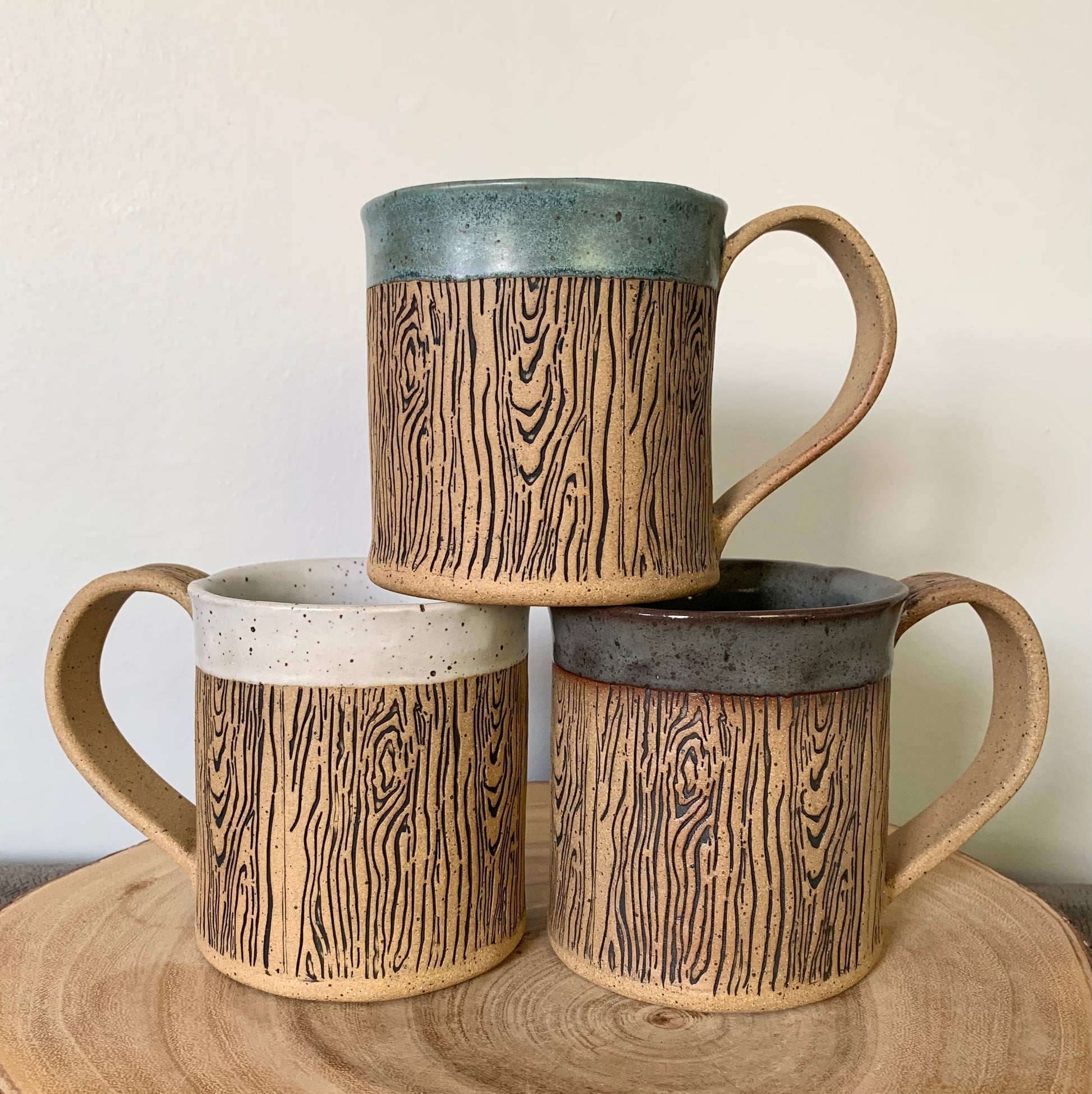 pottery wood grain mug - a stunning and detailed wood grain design wraps around the body of the natural brown speckle pottery mug. The rim is glazed in your choice of white, blue or dark grey glaze. Holds 14 oz.