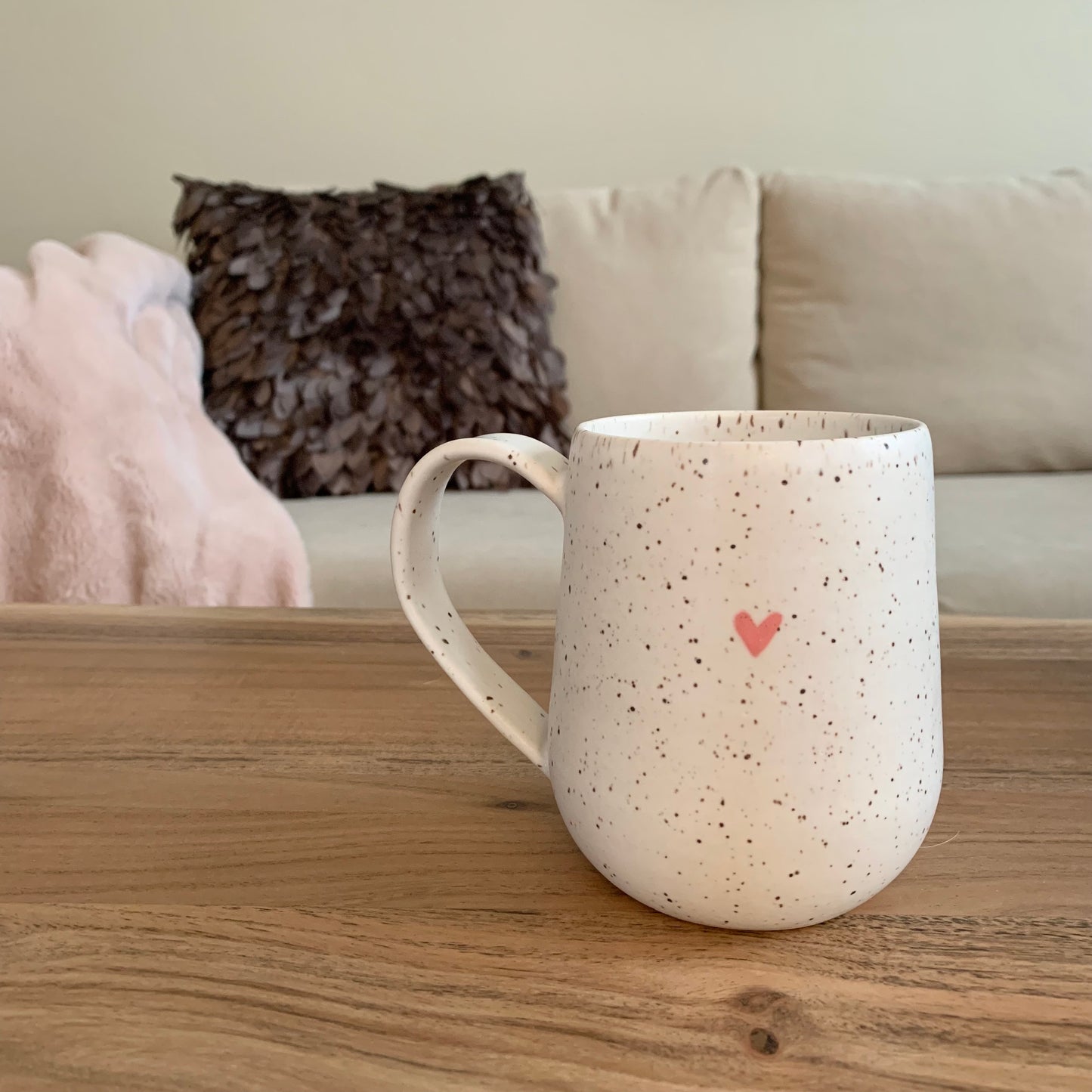 ceramic white speckle sweetheart mug with a cute little pink heart. Microwave and dishwasher safe