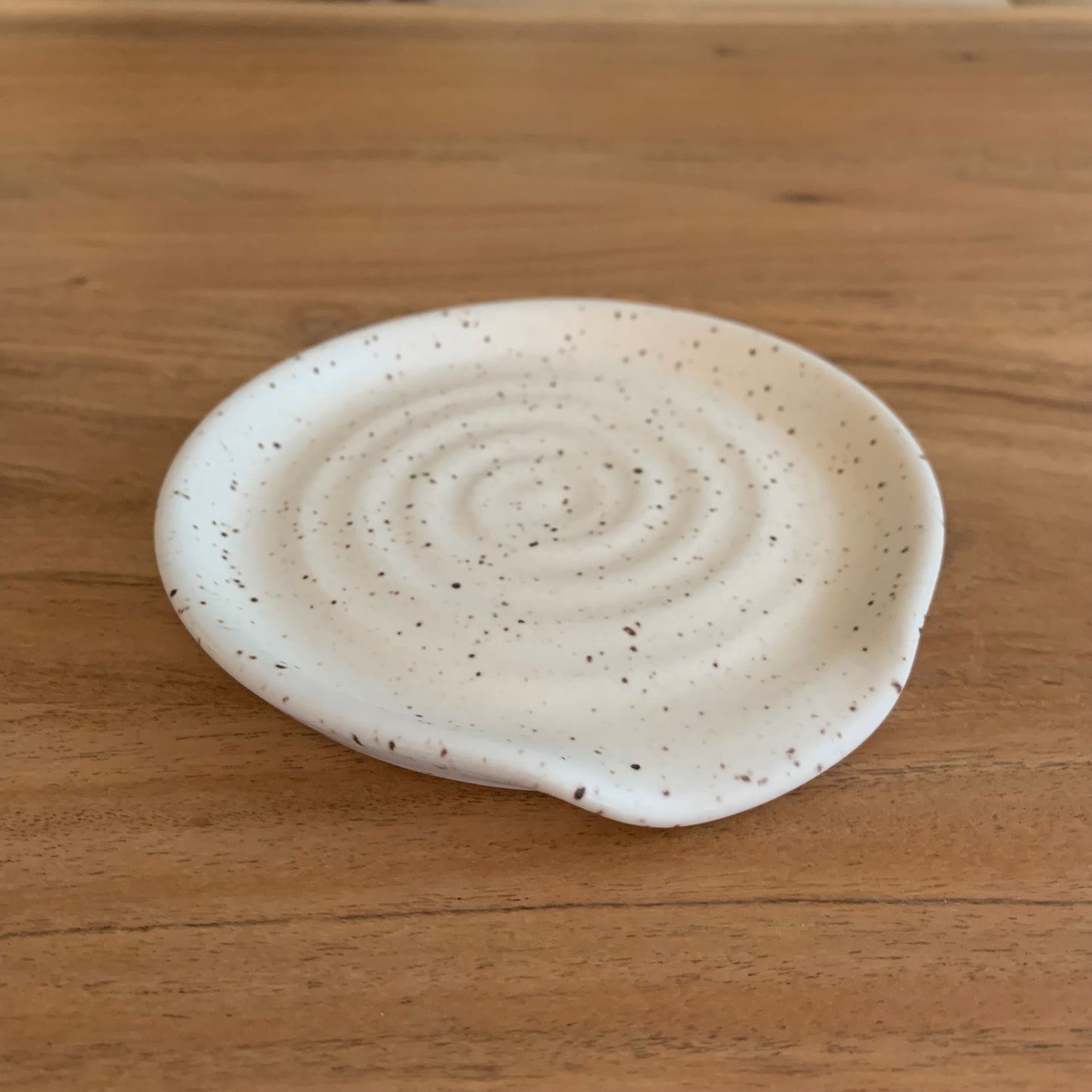 ceramic white speckle spoon rest in a matte finish - approx 4.5" in diameter